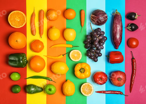 Preview: Rainbow composition with fresh vegetables and fruits on color background, flat lay