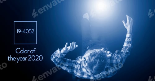 Preview: Handsome Young Male Levitate In Air On Dark Background, Color Of The 2020 Year Trend, Classic Blue