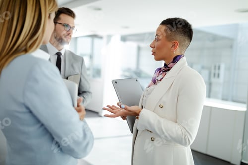 Preview: A group of business people stand in the hallway and discuss about problems in the company.