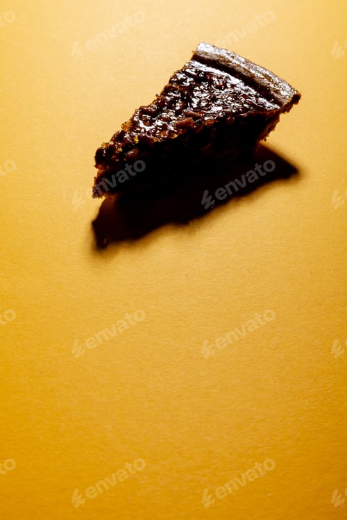 Preview: Composition of piece of pie with shadow on orange background