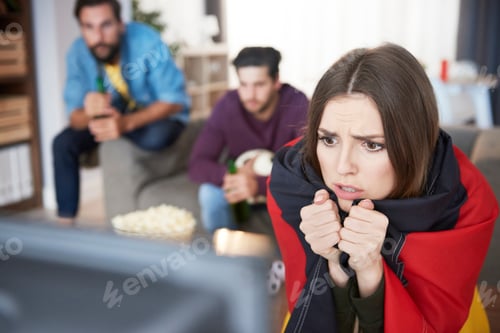 Preview: Worried German football fan watching Tv