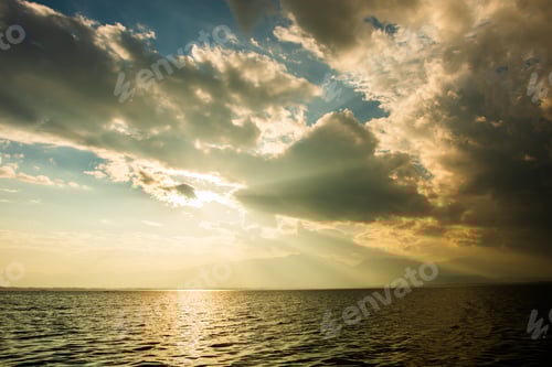 Preview: Golden Hour Light Over Sea and Distant Hills