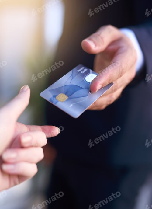 Preview: Paying by card. Cropped shot of a businessman holding out a credit card as payment.