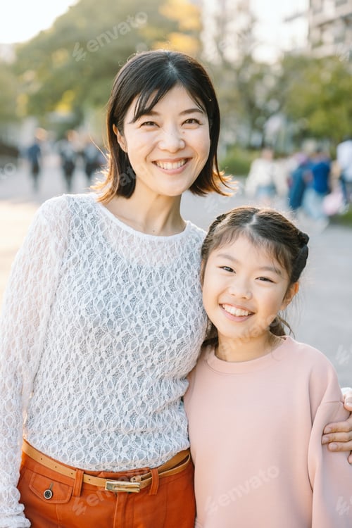 Preview: Happy asian mother and daughter embracing in a park in Tokyo Japan