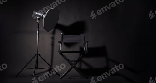 Preview: Black Director chair and studio light on black background.