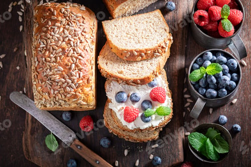 Preview: Healthy and homemade whole grain bread with cheese and berries.