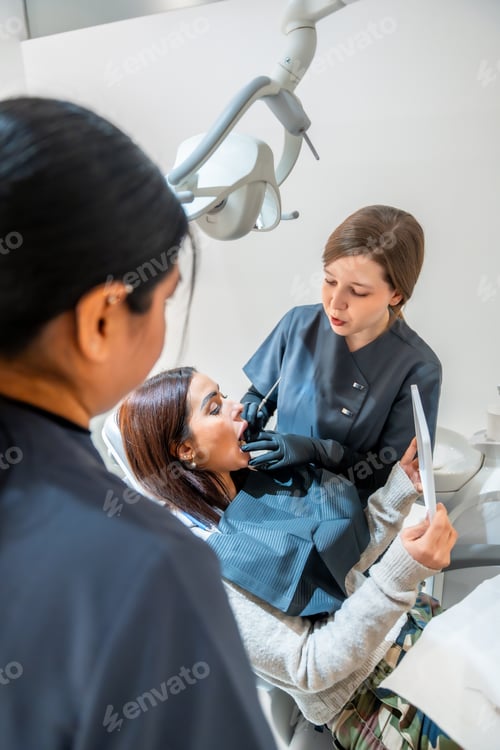 Preview: Dentist performing checkup on patient's teeth in modern clinic