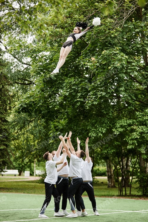 Preview: Cheerleader team doing tricks outdoors