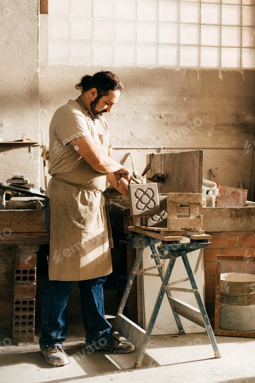 Preview: Diabetic Craftsman in Workshop Placing Barcelona Panot Tile on Drying Rack