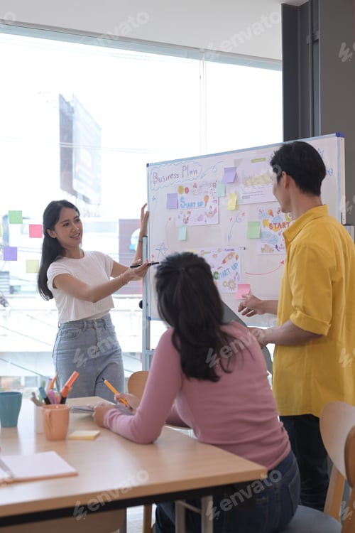 Preview: Beautiful asian woman giving presentation start up business strategy in meeting.