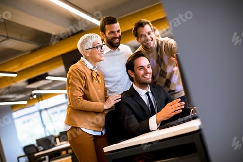 Preview: Senior businesswoman working together with young business people in office