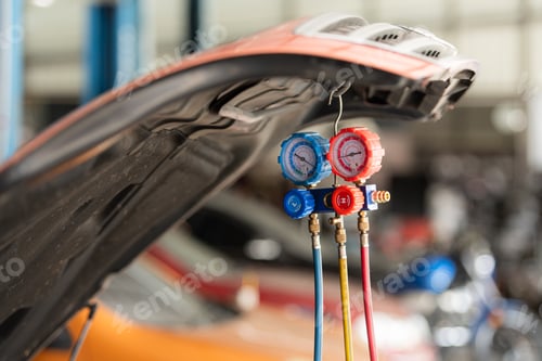 Preview: Car mechanic working in auto repair shop, inspecting the operation of the car's air conditioner