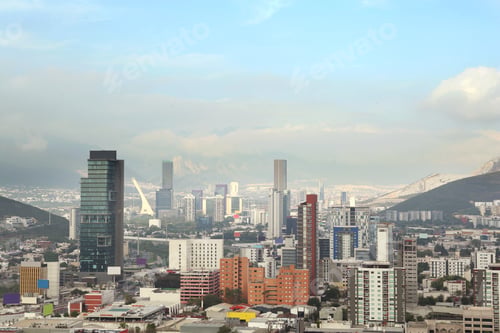 Preview: Picturesque view of cityscape with many buildings near mountain
