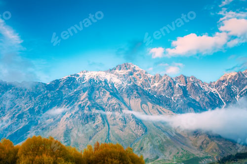 Preview: Clouds Over Rocks. Mountain Peaks Covered With Snow. Varied Moun