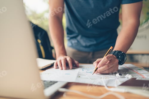 Preview: Tourist planning vacation use pen pointing on the map