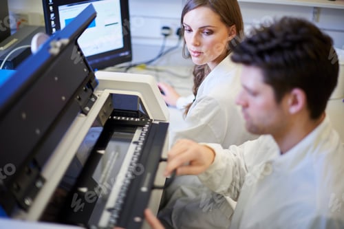 Preview: Two lab technicians operating scientific equipment