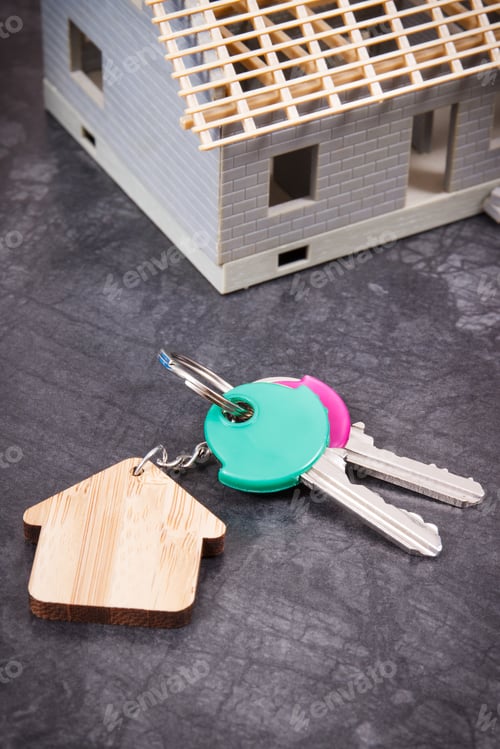 Preview: Small house under construction and keys. Building home concept