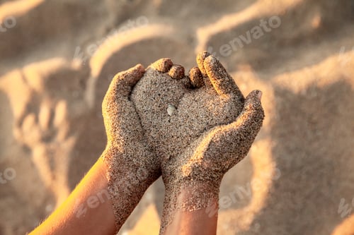 Preview: Hands holding sand, kid playing with sand at the beach, childhood and vacation concept - Image