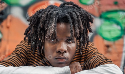 Preview: Portrait of young handsome stylish black man with natural hair dreadlocks. Afroamerican guy. Stairs,