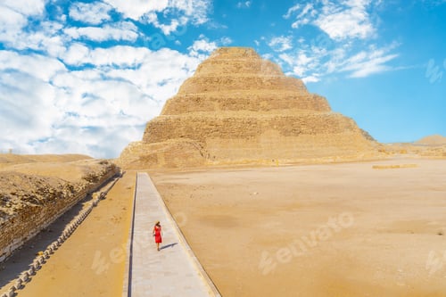 Preview: A young girl in a red dress walking in the Stepped Pyramid of Djoser
