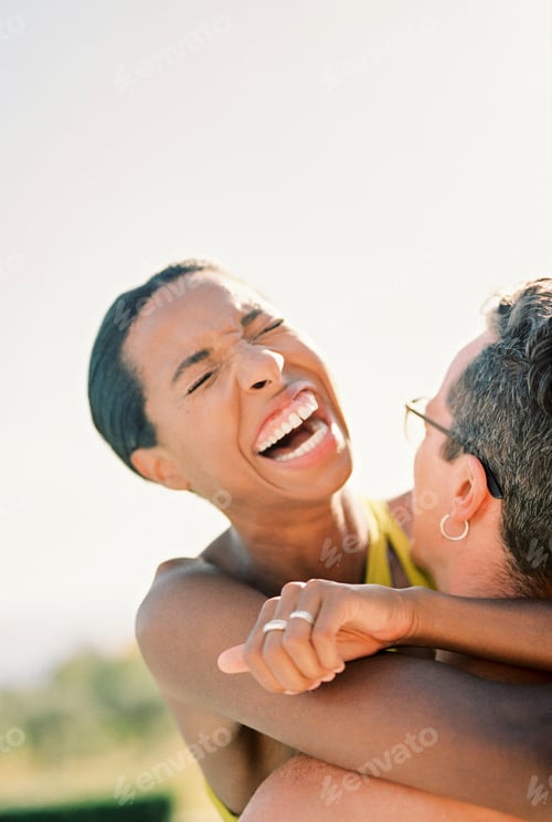Preview: Woman laughs, hugging man neck. Close-up