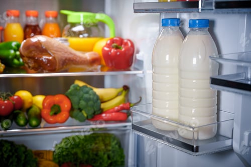 Preview: Products in the refrigerator. Bottles of milk in the fridge
