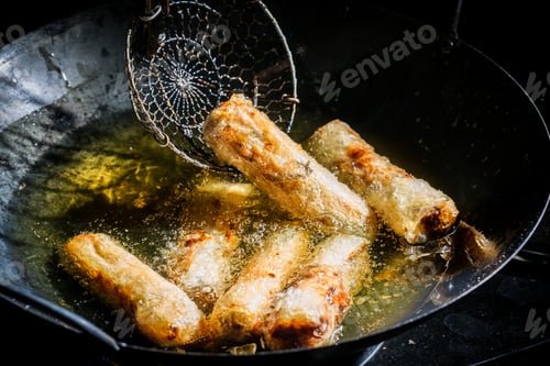 Preview: Tasty spring rolls frying in hot oil