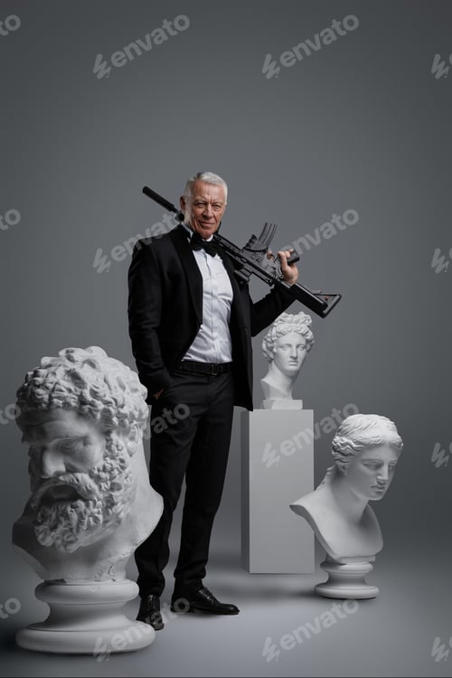 Preview: Stylish older man in expensive suit holding gun surrounded by ancient sculptures