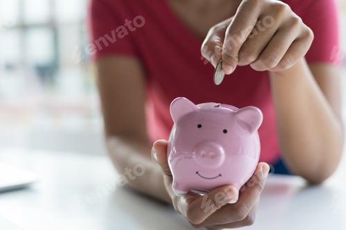 Preview: Woman Saving Money in a Piggy Bank