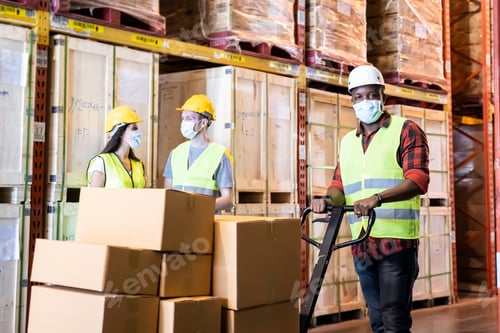 Preview: Interracial workers hold tablet talking and push cart in warehouse store.