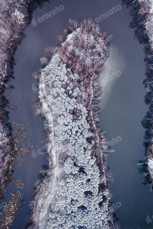 Preview: Aerial view of frozen forest and cold river in winter.