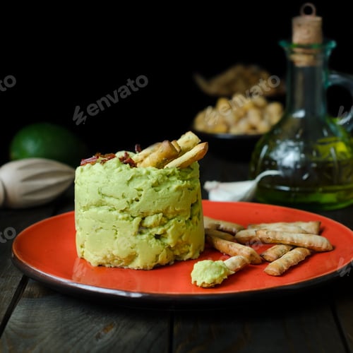 Preview: Avocado Hummus with mini grissini, rustic still life