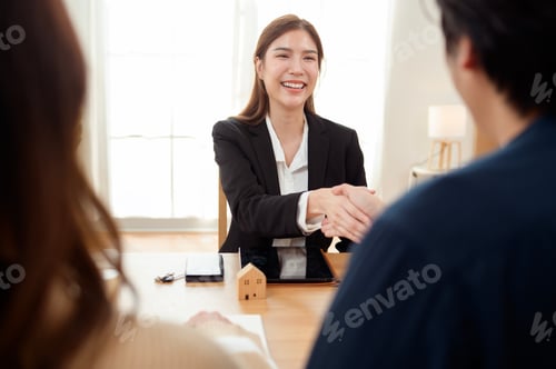 Preview: Professional Woman Shaking Hands With Clients in a Bright Office During a Business Meeting
