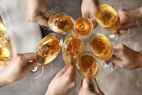 Preview: People clinking glasses with champagne over table, top view