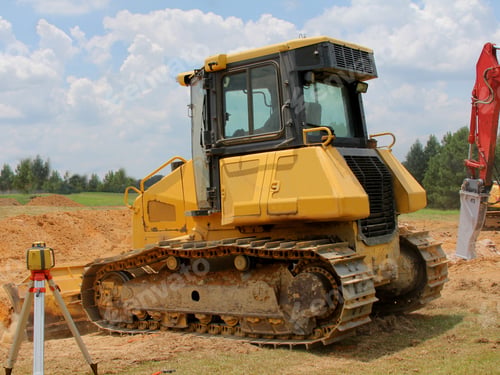 Preview: Construction Vehicle Working - Photograph Of A Construction Vehicle Working And Moving Dirt Around.