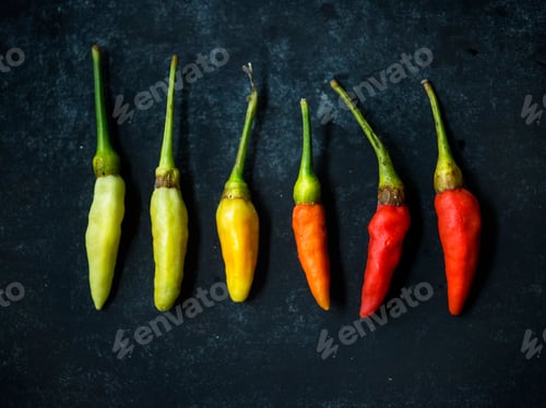 Preview: Aerial view of multi color of chili pepper on black background