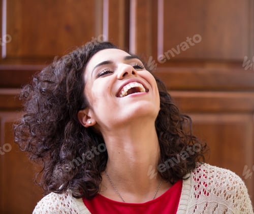 Preview: Young woman with head back laughing