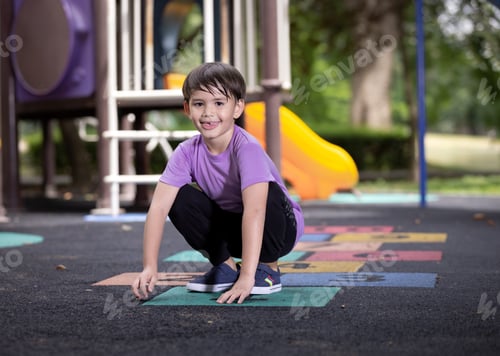 Preview: Active little boy playing hopscotch on playground at outdoor.