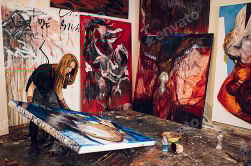 Preview: Female painter artist painting and creating her art in a creative studio