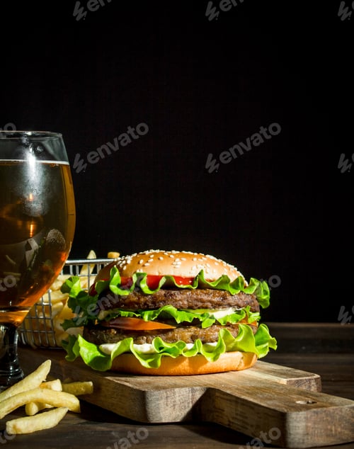 Preview: Burger with beer in a glass and fries.