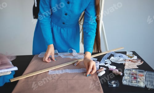 Preview: young woman seamstress at workplace