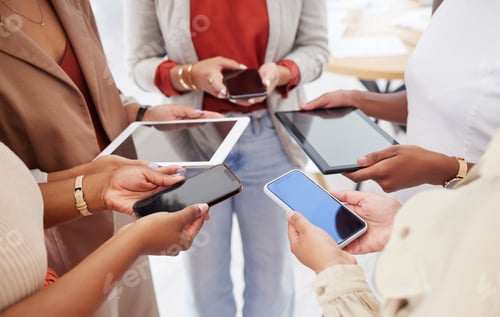 Preview: Diverse group of unknown ambitious businesswomen huddled together and using cellphones in the middl