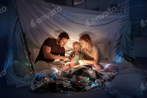 Preview: Family sitting in a teepee, reading stories with the flashlight