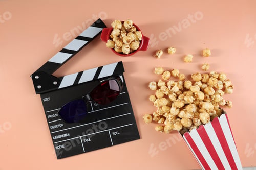 Preview: Tasty Popcorn in Paper Buckets, Movie Clapper and 3D Eyeglasses on a Bright Colored Background.