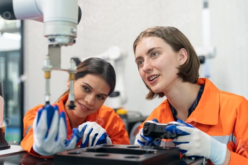 Preview: Female Engineer check and control automation robot arms machine in factory. robotics manufacturing.