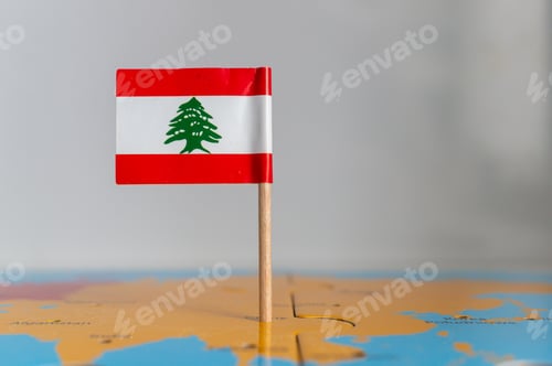 Preview: Small rotated flag of Portugal on a wooden stick fixed on the globe