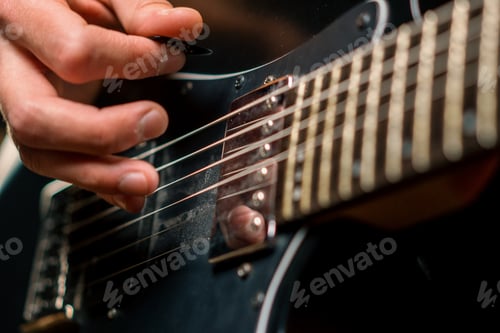 Preview: rock performer with electric guitar in recording studio recording playing track