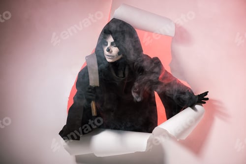 Preview: woman in death costume holding cleaver and getting out of hole in paper