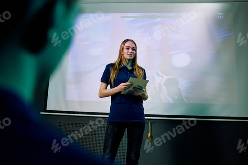 Preview: Young confident female developer of new network video game with tablet