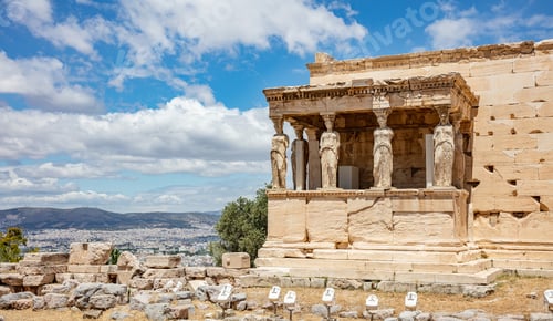 Preview: Athens, Greece. Erechtheion with Cariatides Porch on Acropolis hill, blue sky background